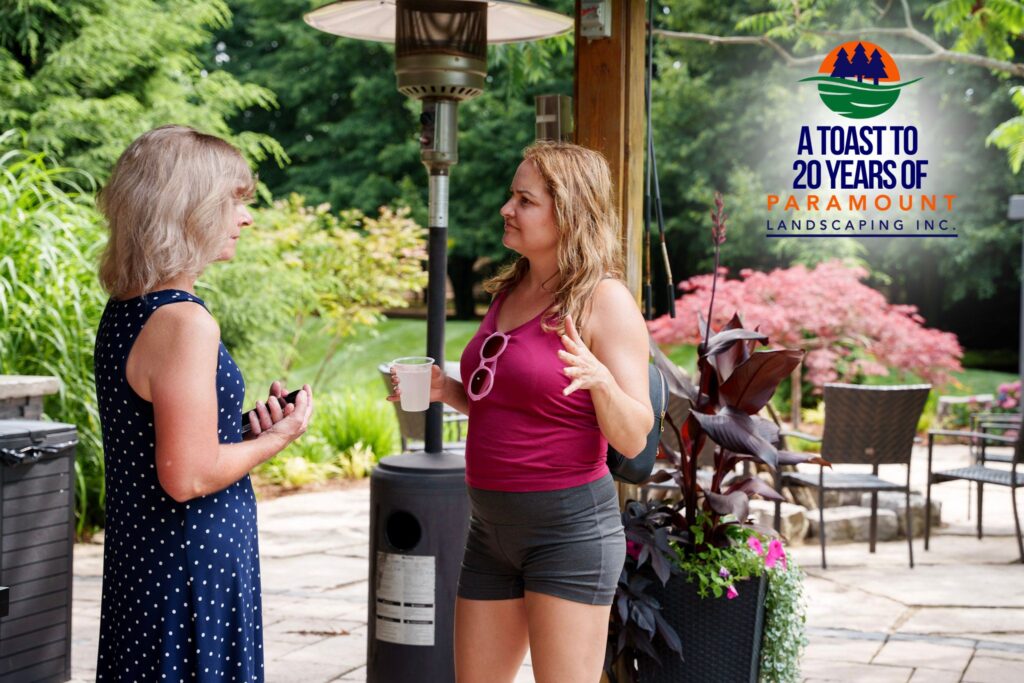 Diana from Paramount Landscaping speaking with a property manager guest during the 20th Anniversary celebration.