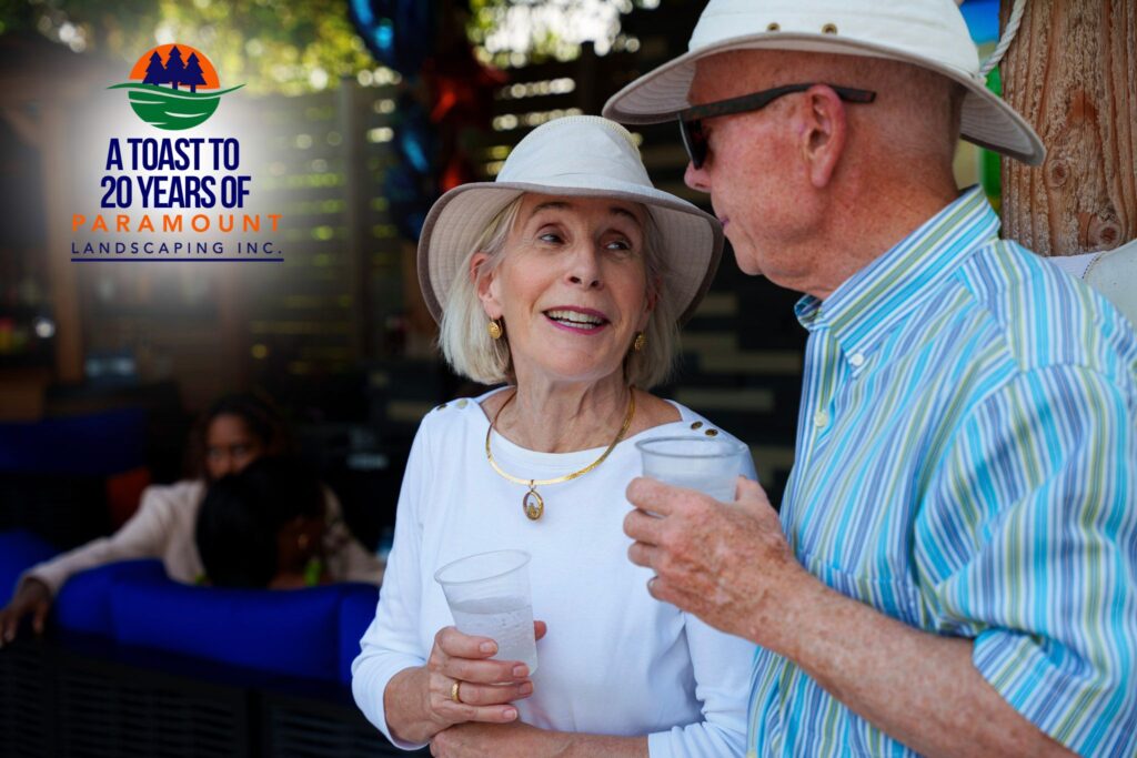 Two residential clients smiling and posing together during Paramount Landscaping’s 20th Anniversary celebration.