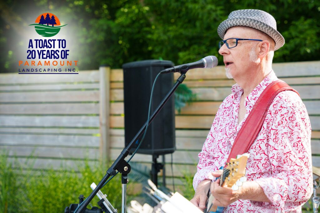 Lead singer of the live band performing at Paramount Landscaping's 20th Anniversary event.