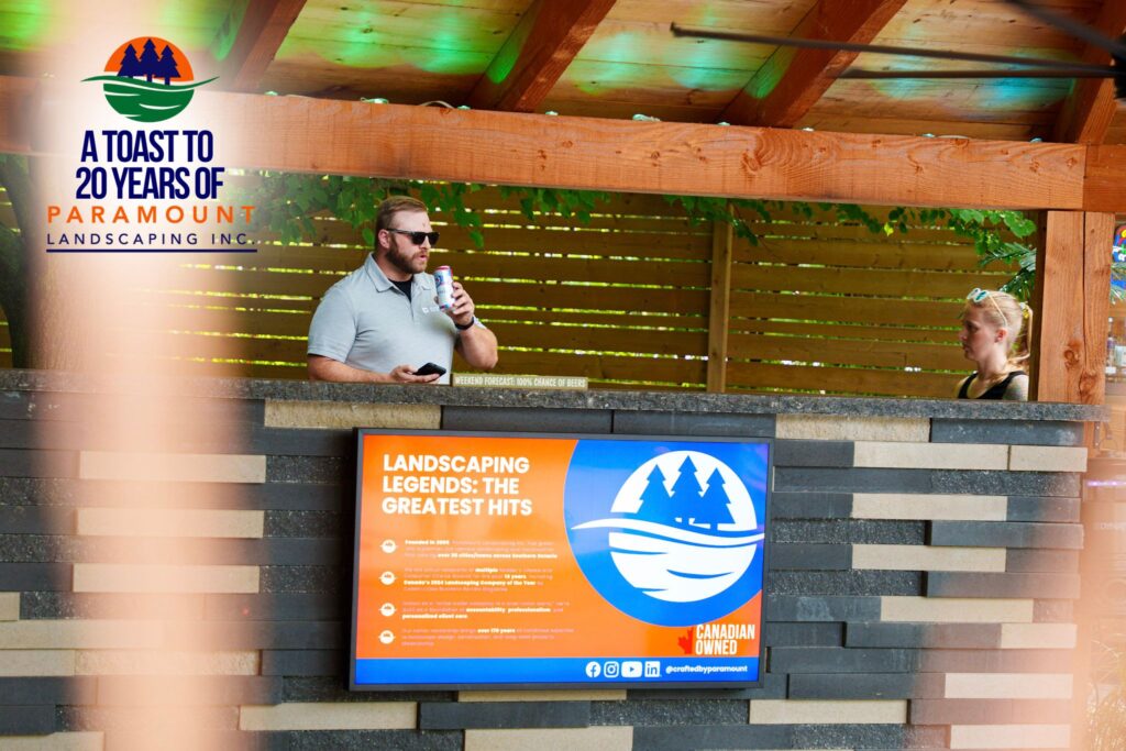 Paramount Landscaping 20th anniversary display board showcasing company milestones, Canadian ownership, and industry awards.