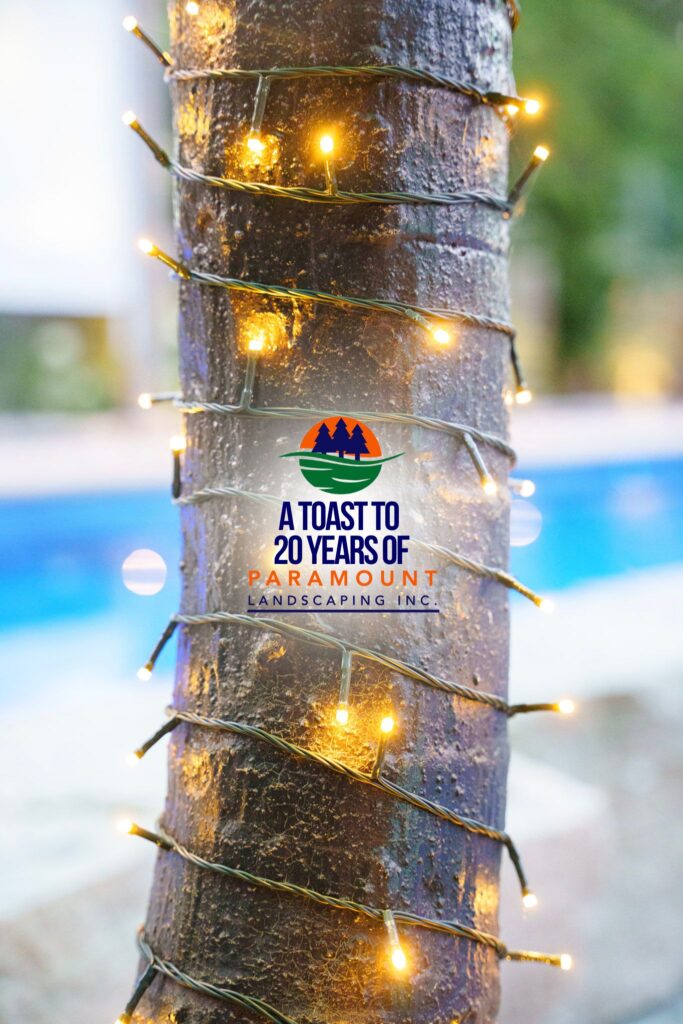 Close-up of the faux palm tree trunk featuring warm-toned landscaping lights at Paramount Landscaping’s 20th Anniversary celebration.