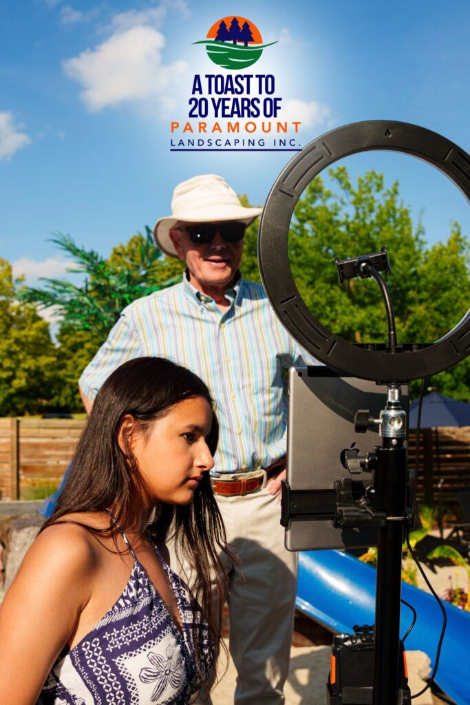 Two guests operating the 360 photo booth camera at Paramount Landscaping's 20th Anniversary celebration.