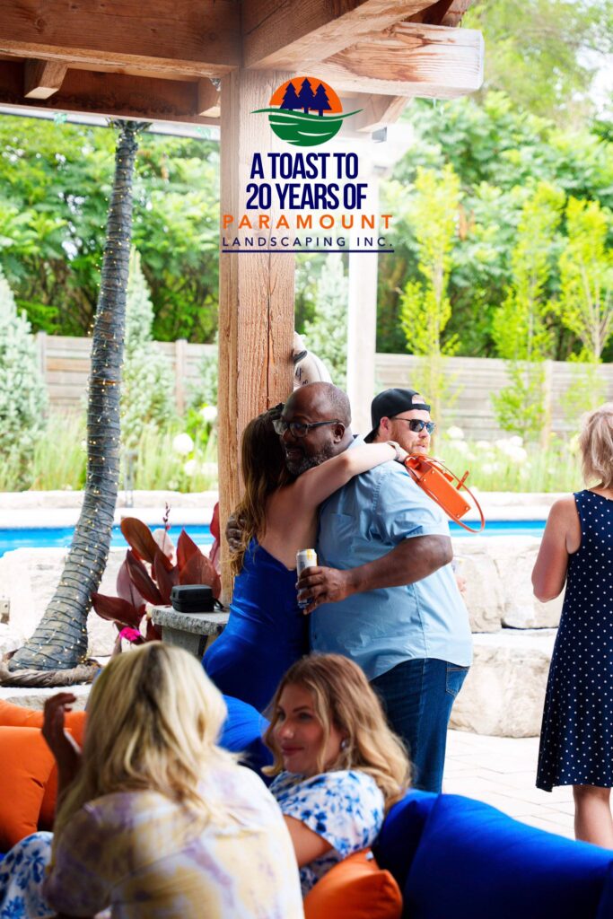 Melissa Rolston hugging Barrington Miller during Paramount Landscaping’s 20th Anniversary celebration.