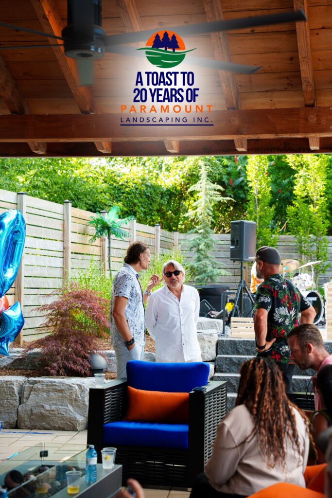 Guests gather under the shade near the Big Ass Fans installation at the 20th Anniversary event.