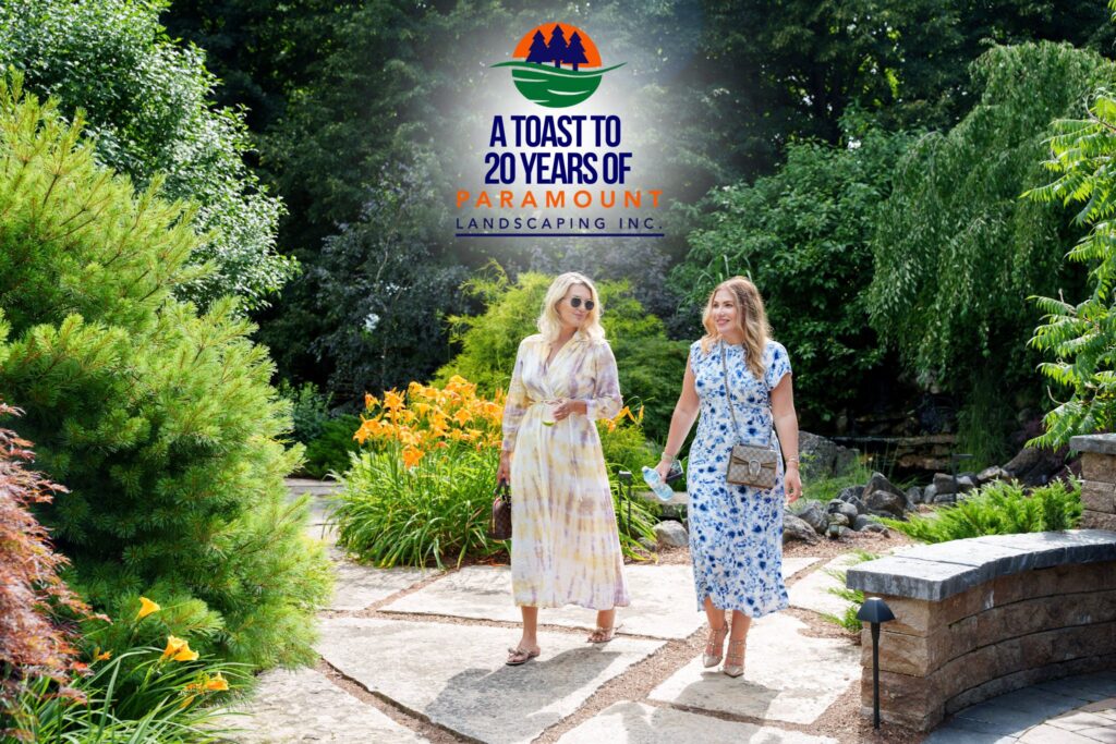 Three guests walking toward the camera down Paramount’s stone walkway, with the branded Discovery Lounge sign visible in the background.