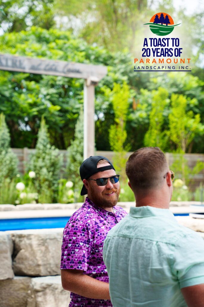 Three Digital21 team members engaged in conversation during Paramount Landscaping’s 20th Anniversary celebration poolside