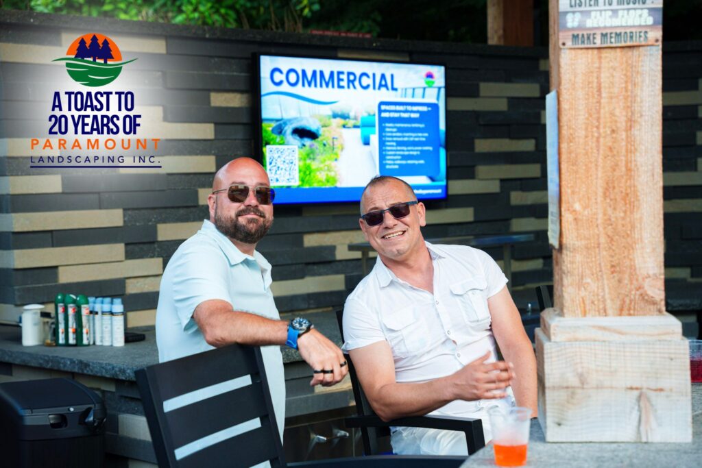 Doug Dolson of Paramount Landscaping seated with Lou from Zoran Properties during the 20th Anniversary Celebration at the Discovery Lounge.