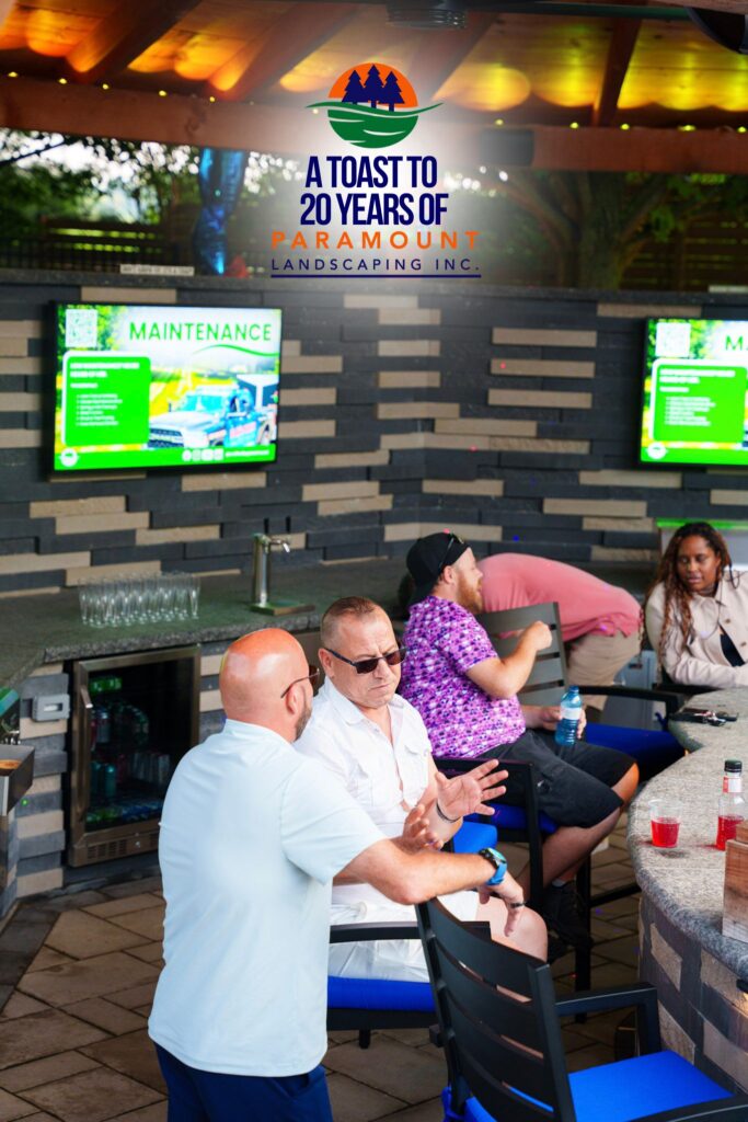 Doug Dolson of Paramount Landscaping chatting with Lou from Zoran Properties during the 20th Anniversary Celebration inside the Discovery Lounge.