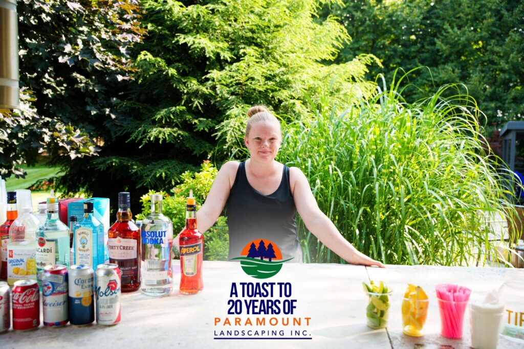 Bartender from Two Hot Blondes Bartending Services pours a drink at Paramount Landscaping's 20th Anniversary.